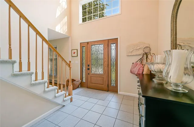 a view of a hallway with windows and chandelier