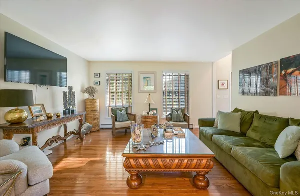 a living room with furniture wooden floor and a flat screen tv
