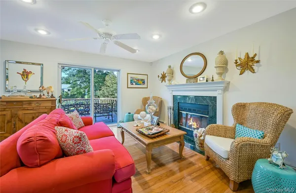 a living room with furniture fireplace and a large window
