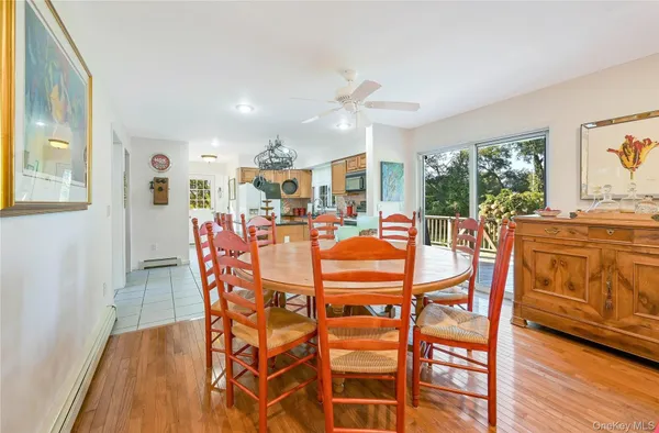 a dining room filled chandelier and wooden floor