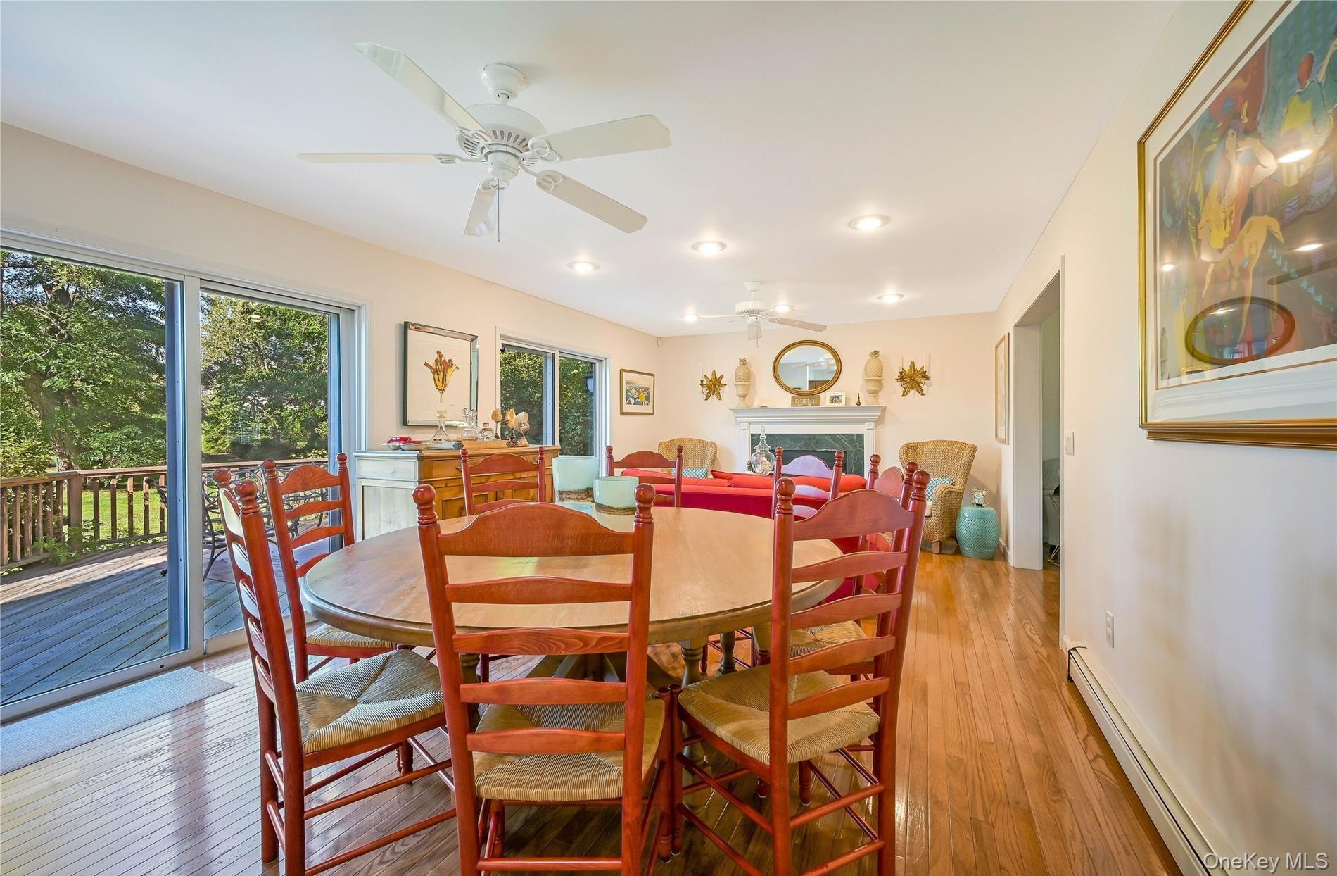 215 Kouros Road New Suffolk, NY 11956 - Photo 9 of 28 a view of a dining room with furniture window and wooden floor