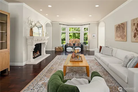 a living room with furniture fireplace and window