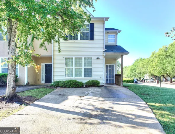 a front view of a house with a yard and a garage