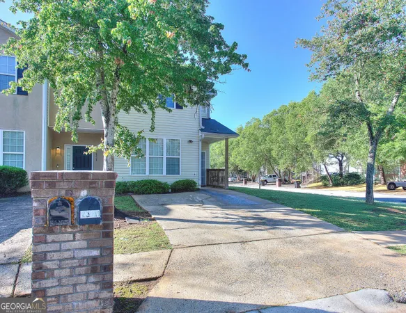 a view of a house with a yard and tree s
