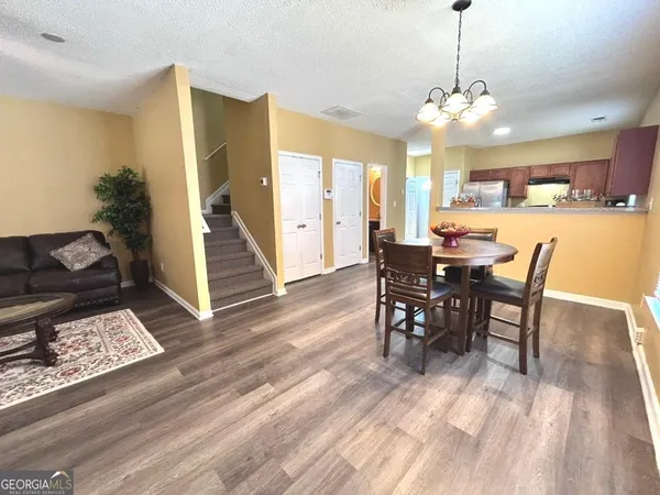 a view of a dining room with furniture window and wooden floor