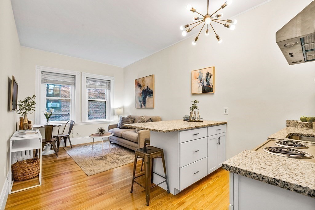 481 Beacon Street, Unit 43 Boston, MA 02115 - Photo 3 of 10 a living room with stainless steel appliances granite countertop furniture and a kitchen view