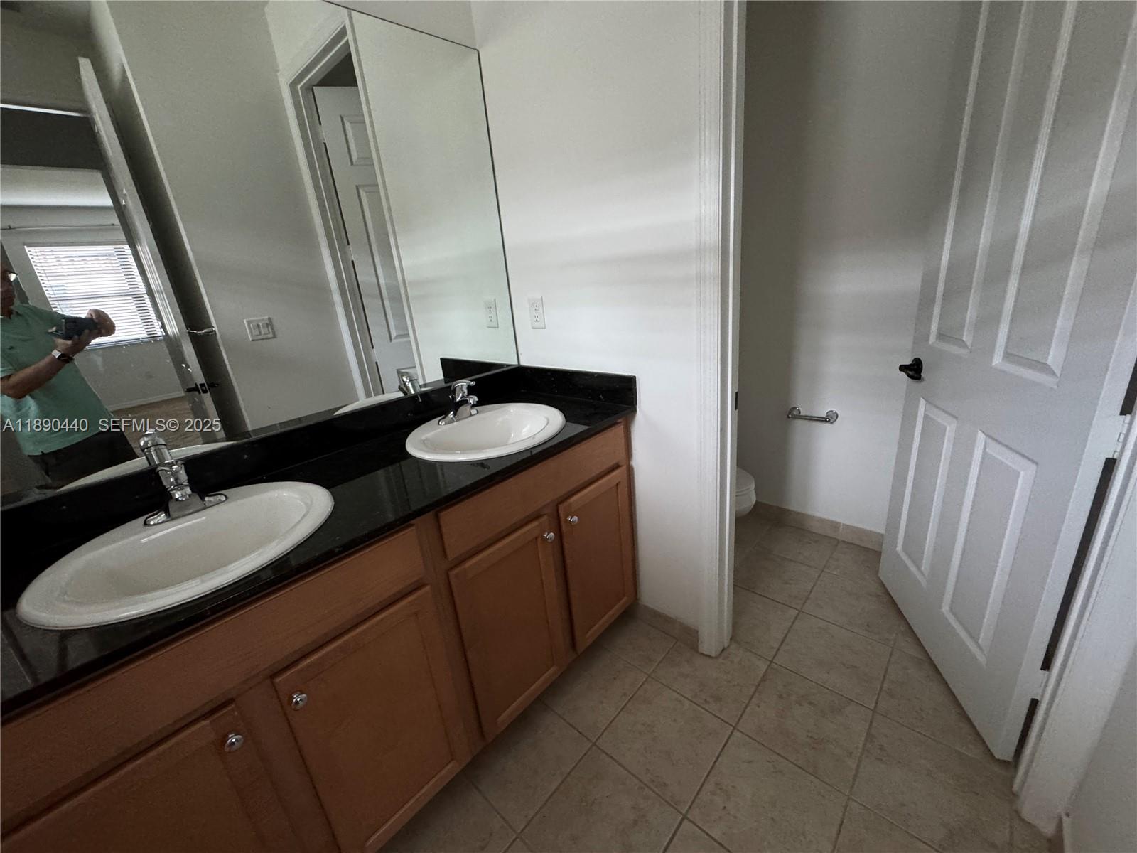 9079 Southwest 35th Street Miramar, FL 33025 - Photo 19 of 21 a bathroom with a double vanity sink and a mirror