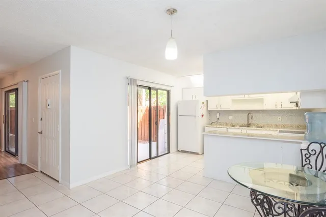 a kitchen with stainless steel appliances granite countertop a sink and a refrigerator