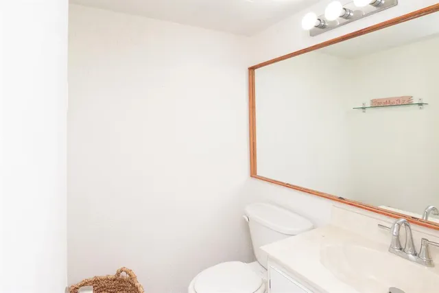 a white toilet sitting next to a bathroom sink