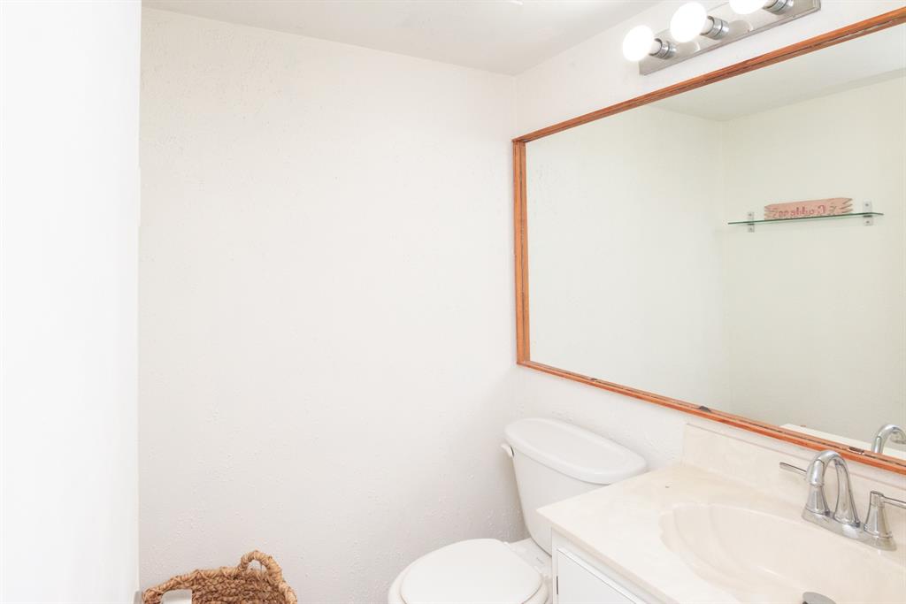 3118 Spanish Wells Drive, Unit 15C Delray Beach, FL 33445 - Photo 15 of 40 a white toilet sitting next to a bathroom sink