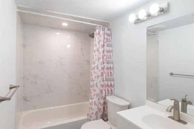 a bathroom with a bathtub a sink and a mirror