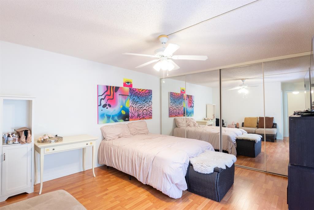 3118 Spanish Wells Drive, Unit 15C Delray Beach, FL 33445 - Photo 20 of 40 a bedroom with furniture and a chandelier