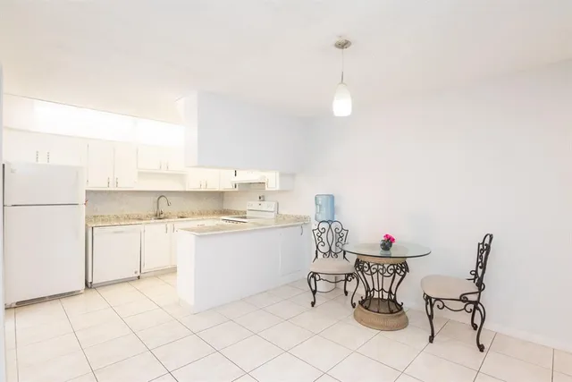 a kitchen with a sink cabinets and window