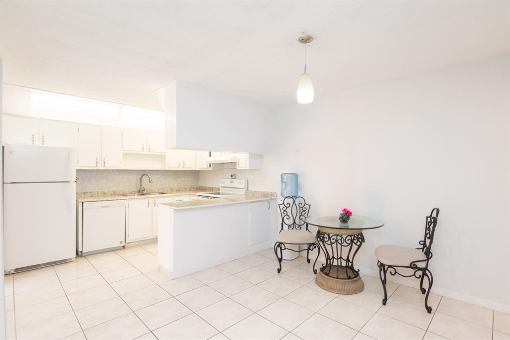 3118 Spanish Wells Drive, Unit 15C Delray Beach, FL 33445 - Photo 8 of 40 a kitchen with a sink cabinets and window