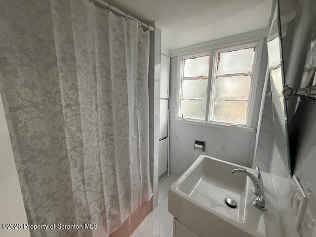 214 William Street Scranton, PA 18508 - Photo 33 of 33 a bathroom with a sink a window and a shower