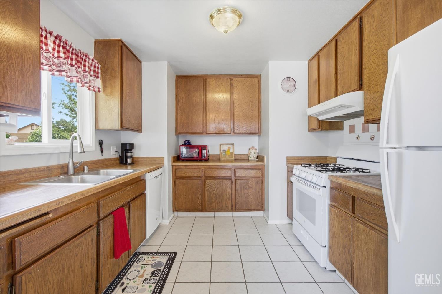Undisclosed Address Tehachapi, CA 93561 - Photo 28 of 48 a kitchen with a sink a stove top oven and cabinets