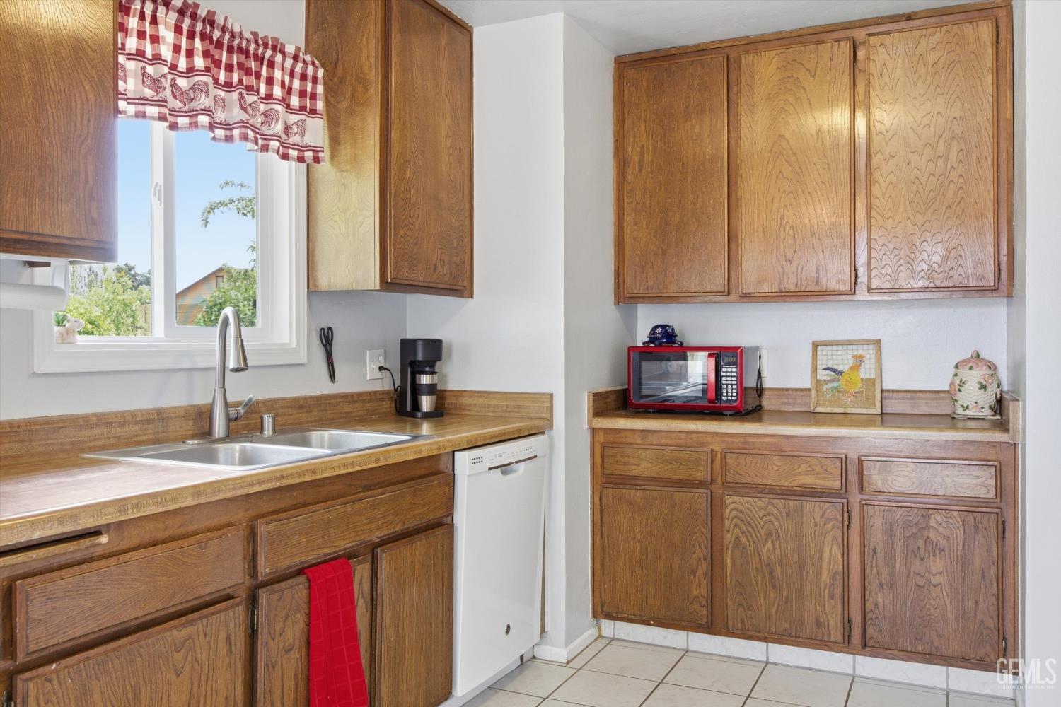 Undisclosed Address Tehachapi, CA 93561 - Photo 29 of 48 a kitchen with a sink window and cabinets