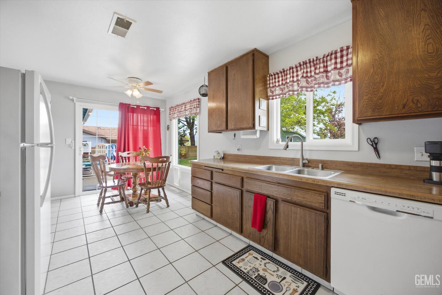 Undisclosed Address Tehachapi, CA 93561 - Photo 32 of 48 a kitchen with stainless steel appliances a sink window and chairs