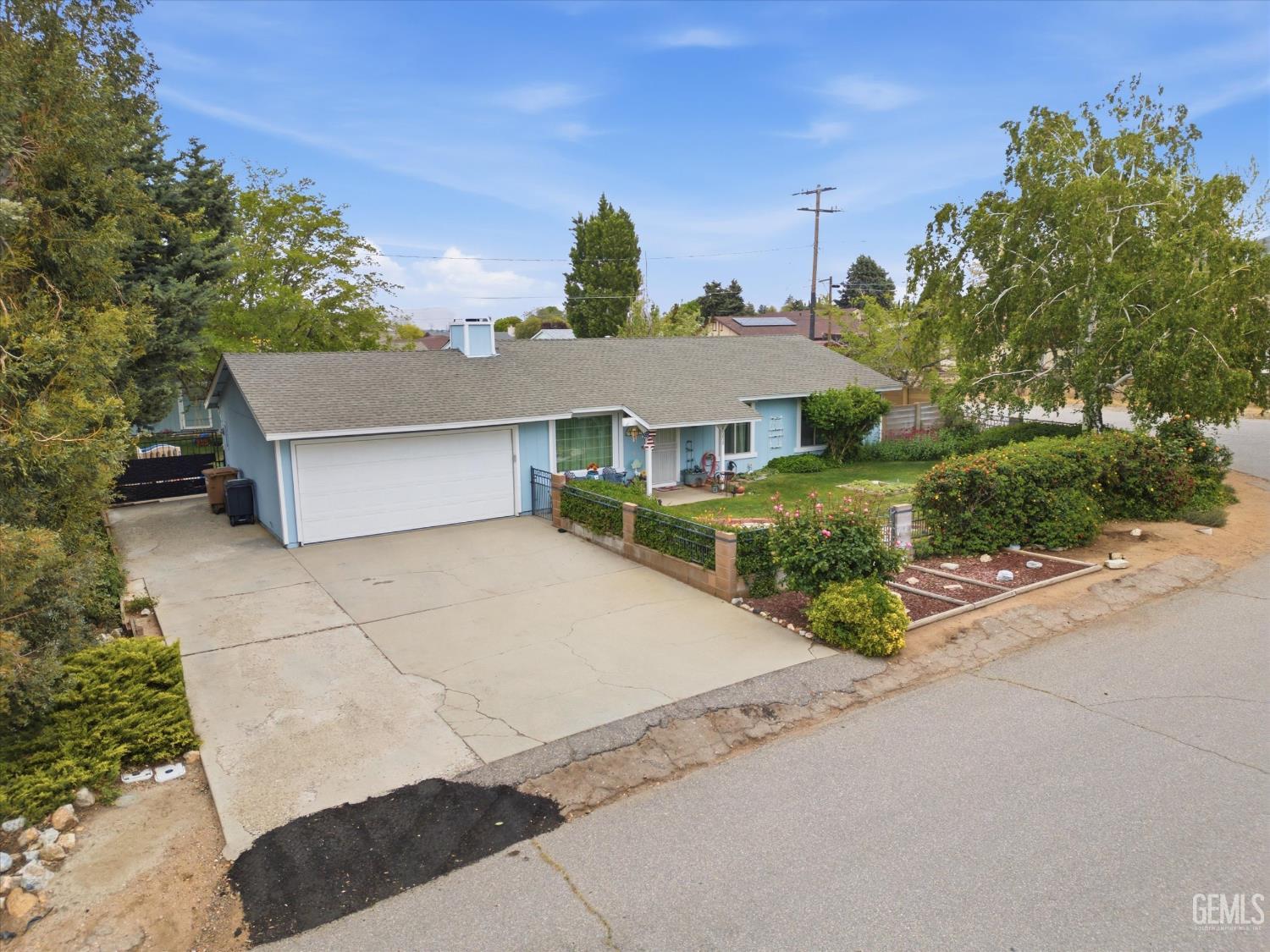 Undisclosed Address Tehachapi, CA 93561 - Photo 6 of 48 a front view of a house with a yard and garage