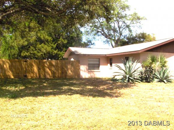 5494 Riverside Drive Port Orange, FL 32127 - Photo 13 of 13 a view of a house with a yard