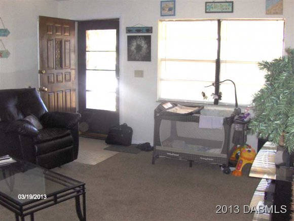 5494 Riverside Drive Port Orange, FL 32127 - Photo 5 of 13 a living room with furniture and a window