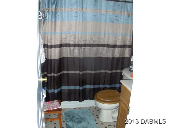 5494 Riverside Drive Port Orange, FL 32127 - Photo 10 of 13 a bathroom with a toilet and a sink