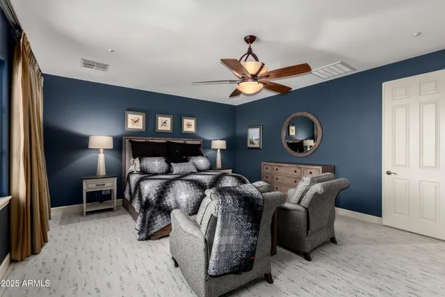 a bathroom with a granite countertop sink a toilet and a large mirror