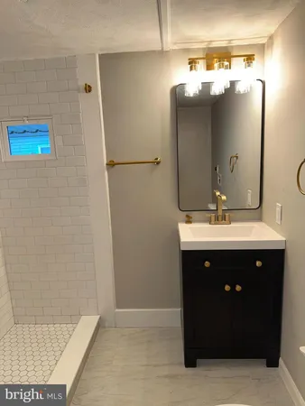 a bathroom with a sink vanity and mirror