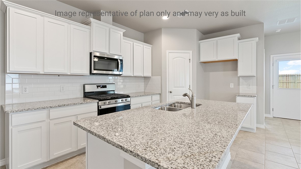 1411 Choctaw Road Sinton, TX 78387 - Photo 6 of 28 a kitchen with stainless steel appliances granite countertop a sink stove and microwave