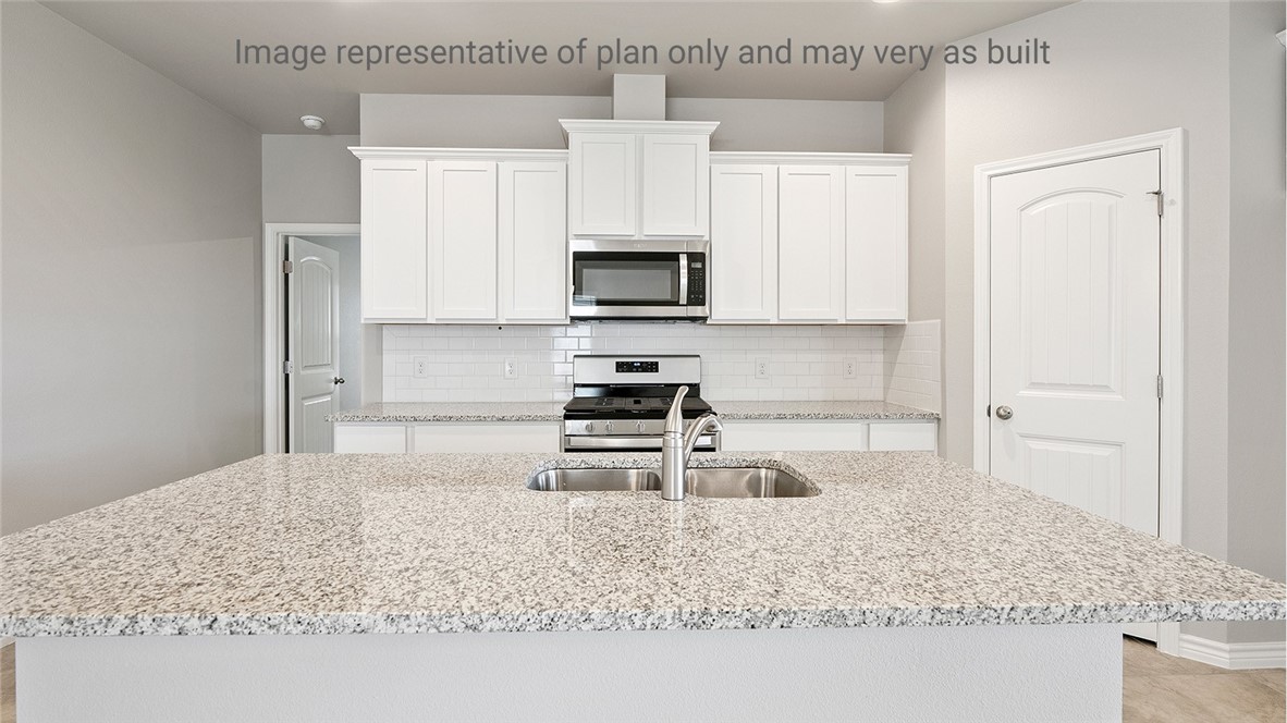 1411 Choctaw Road Sinton, TX 78387 - Photo 8 of 28 a kitchen with granite countertop a sink a stove and cabinets