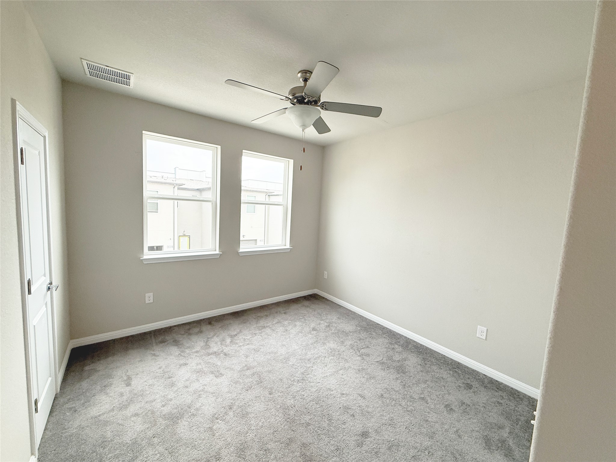 9015 Cattle Baron Path, Unit 605 Austin, TX 78747 - Photo 4 of 20 Carpeted bedroom 2 with visible vents, a ceiling fan, and baseboards