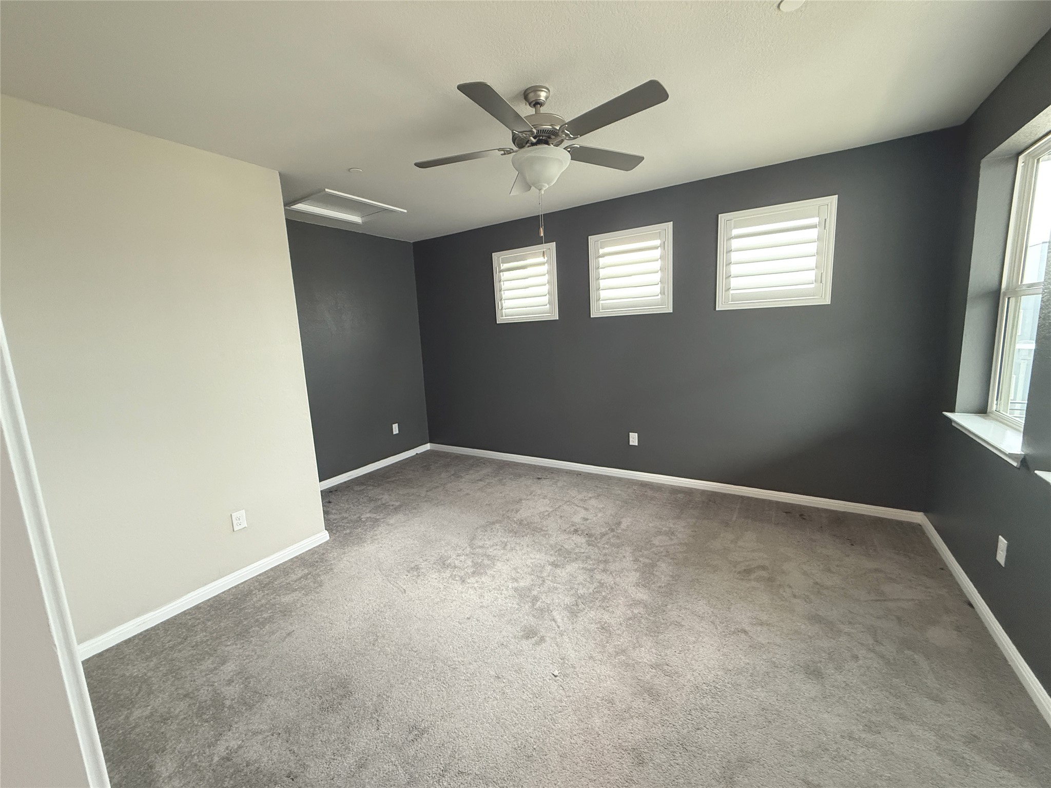 9015 Cattle Baron Path, Unit 605 Austin, TX 78747 - Photo 8 of 20 Spare room with attic access, ceiling fan, carpet floors, and baseboards