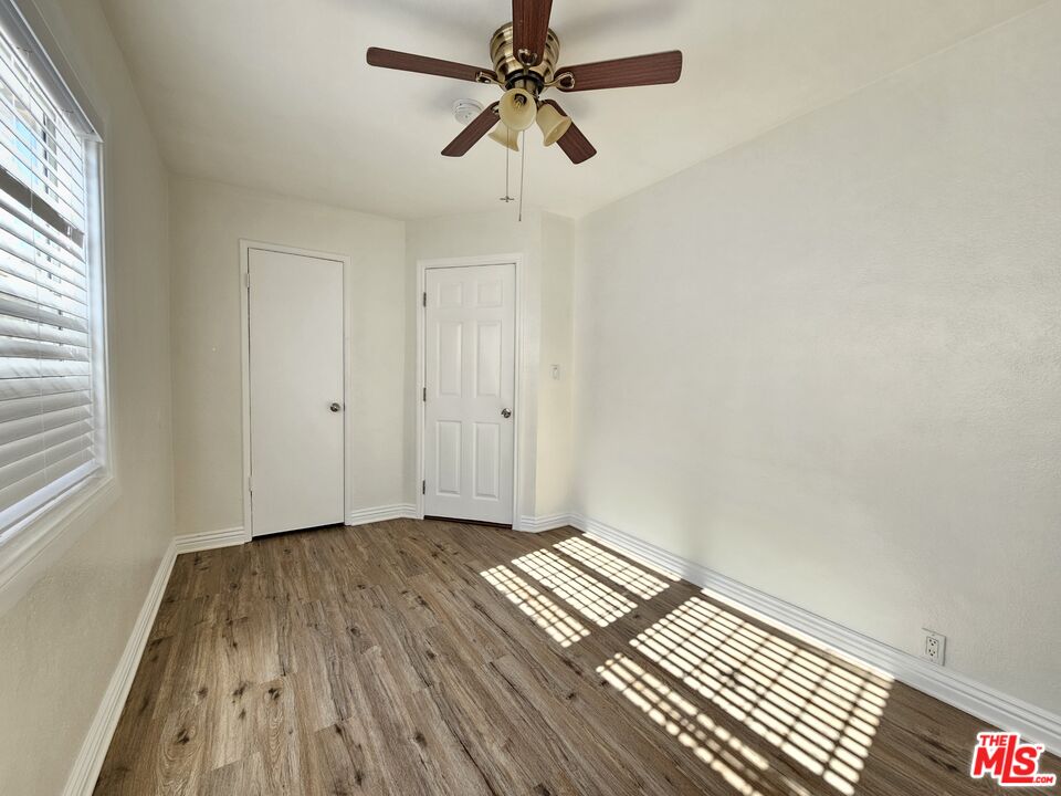 204 North Spring Avenue Compton, CA 90221 - Photo 11 of 14 a view of a room with wooden floor ceiling fan and window