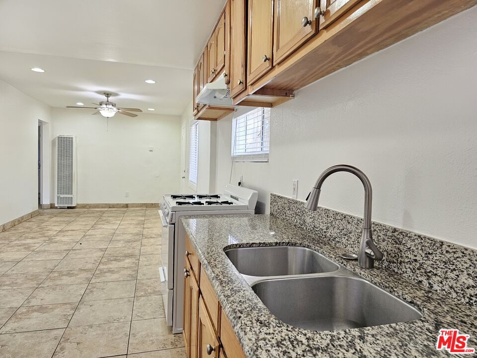 204 North Spring Avenue Compton, CA 90221 - Photo 3 of 14 a kitchen with a sink a stove and cabinets