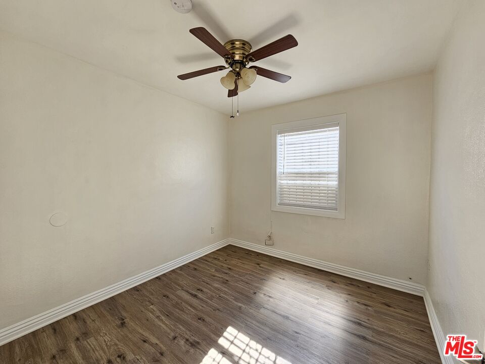204 North Spring Avenue Compton, CA 90221 - Photo 6 of 14 an empty room with wooden floor fan and windows