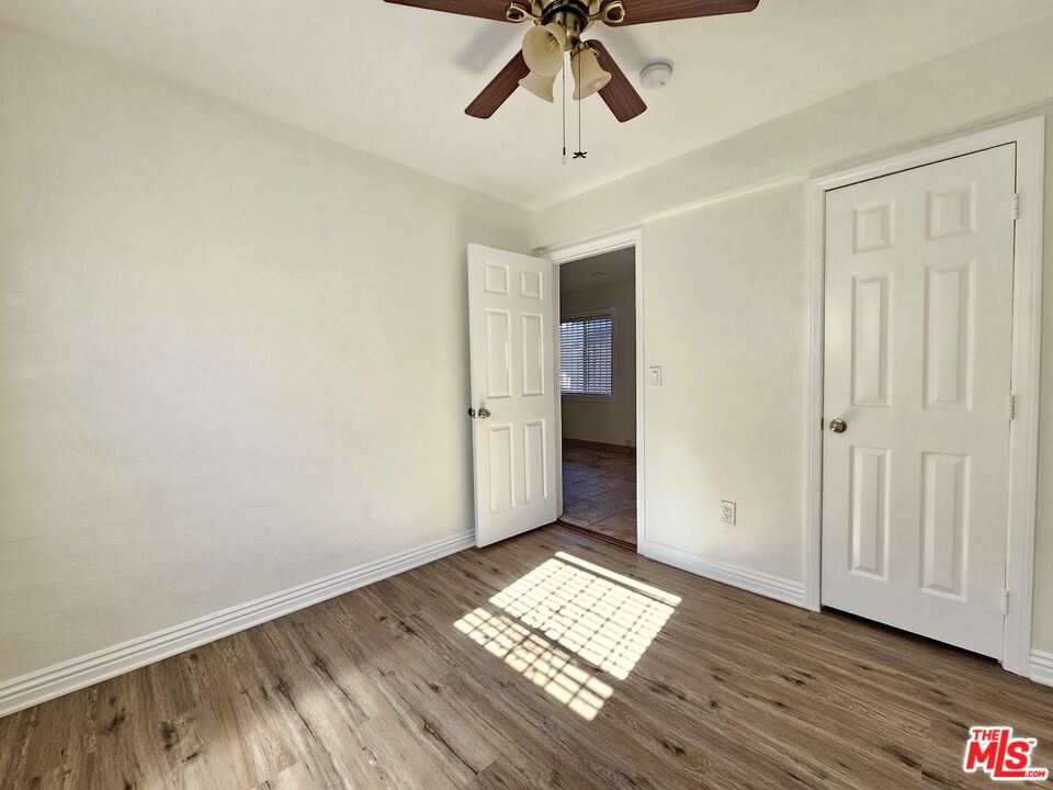 204 North Spring Avenue Compton, CA 90221 - Photo 7 of 14 a view of empty room with wooden floor and fan