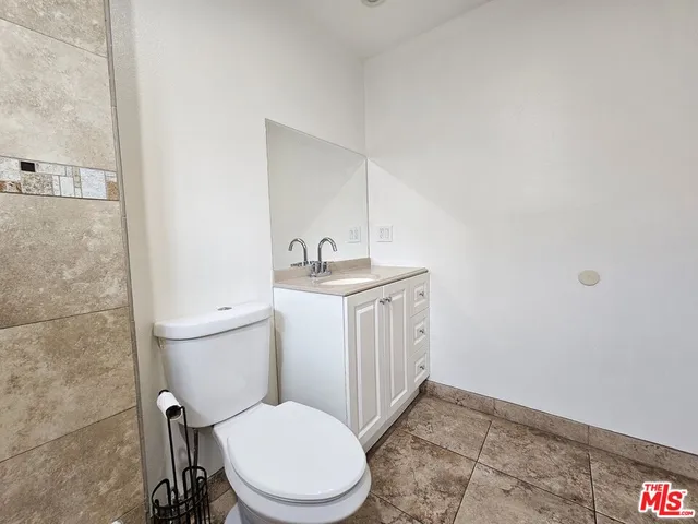 a white toilet sitting next to a bathroom sink