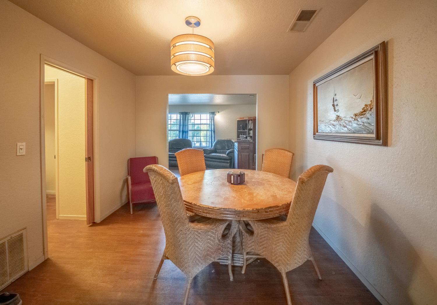 494 Surrey Court Murphys, CA 95247 - Photo 51 of 76 a view of a dining room with furniture and wooden floor