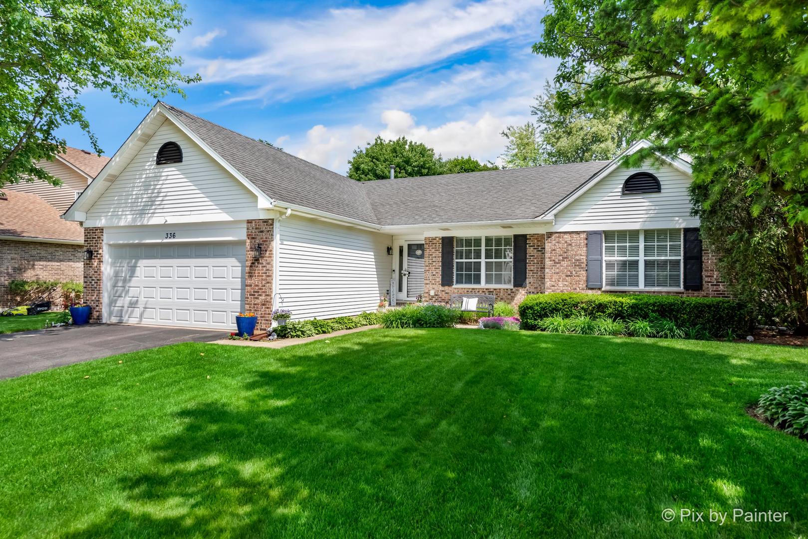 a front view of a house with a yard and garage