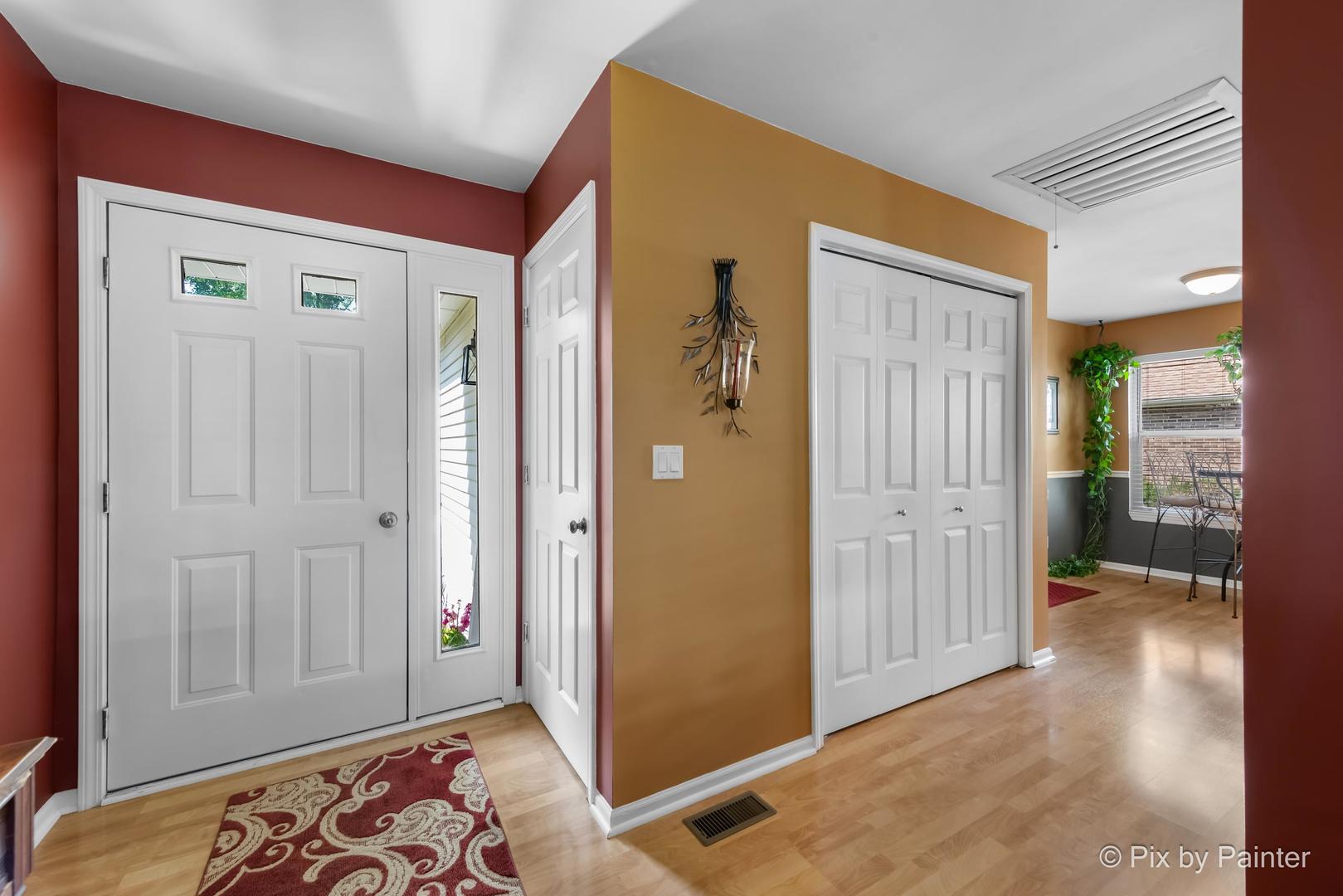 336 Claire Lane Cary, IL 60013 - Photo 11 of 29 a view of a hallway with wooden floor and a bedroom