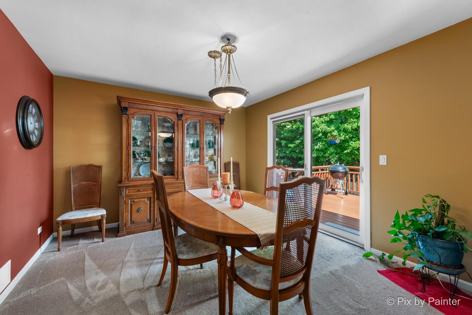 336 Claire Lane Cary, IL 60013 - Photo 18 of 29 a dining room with furniture garden view and a chandelier