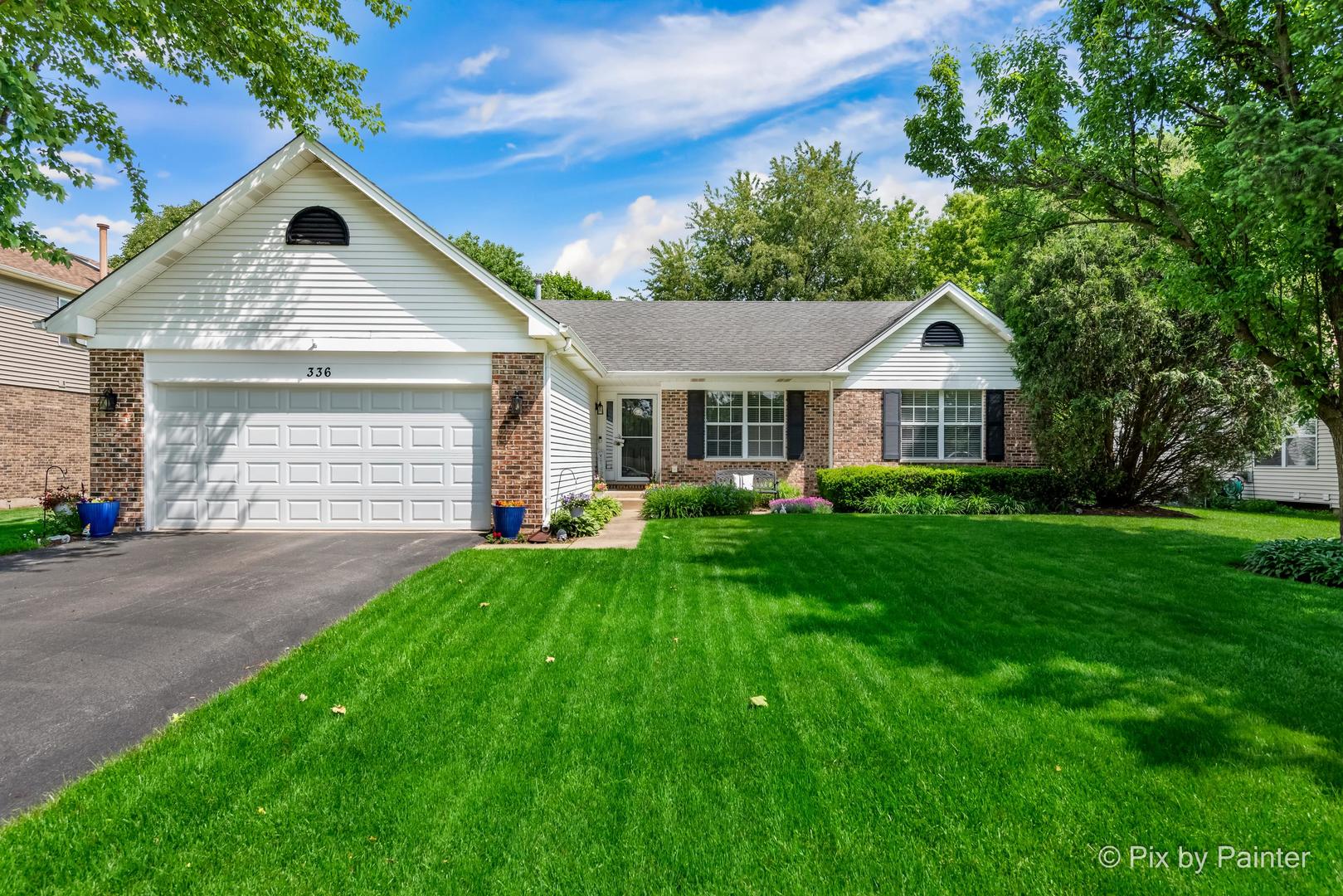 336 Claire Lane Cary, IL 60013 - Photo 2 of 29 a front view of a house with a yard and garage