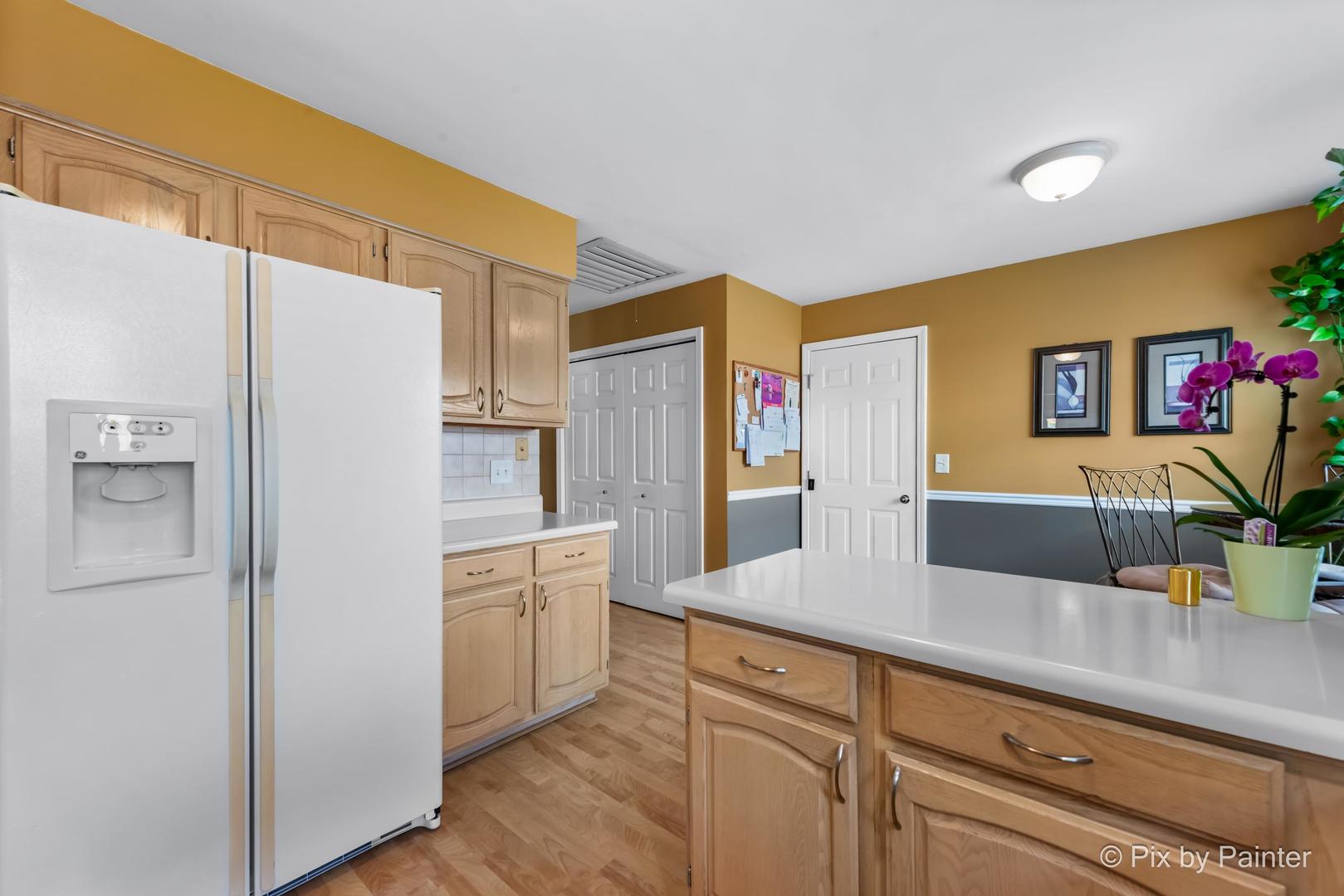 336 Claire Lane Cary, IL 60013 - Photo 22 of 29 a kitchen with stainless steel appliances a refrigerator and cabinets