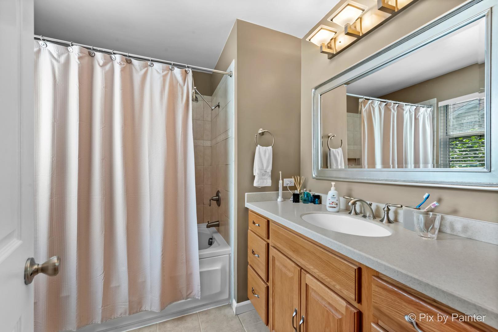 336 Claire Lane Cary, IL 60013 - Photo 26 of 29 a bathroom with a double vanity sink and a mirror