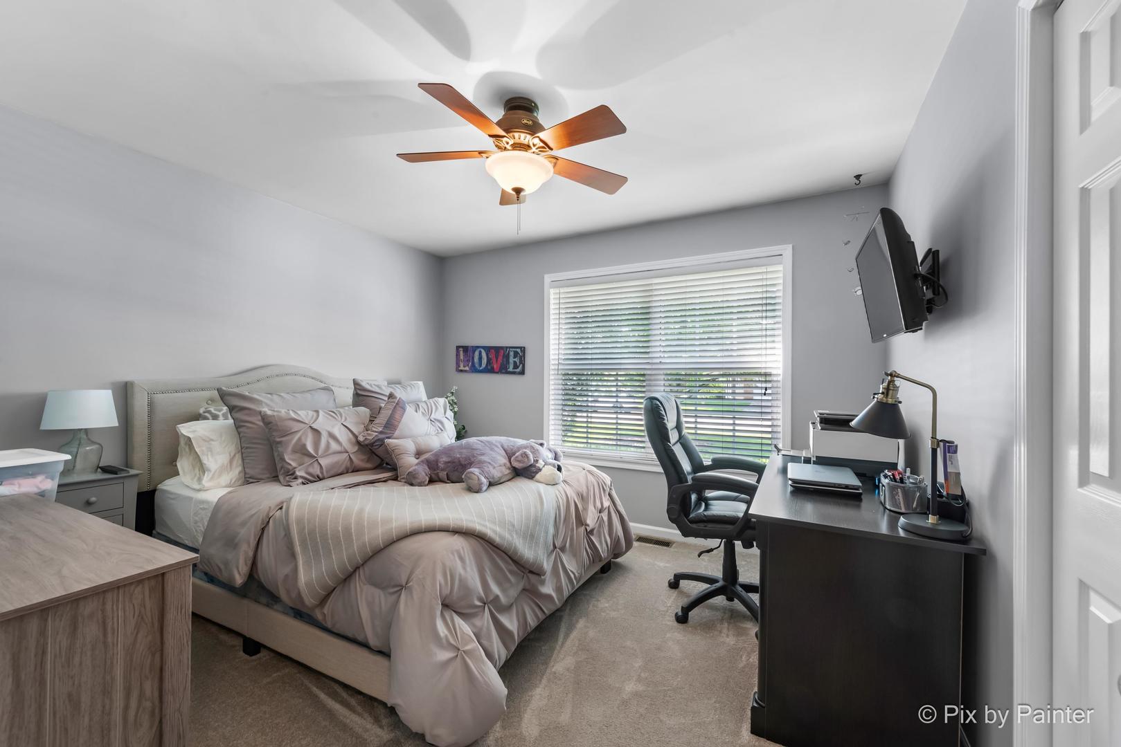 336 Claire Lane Cary, IL 60013 - Photo 28 of 29 a bedroom with a large bed and a flat tv screen on dresser