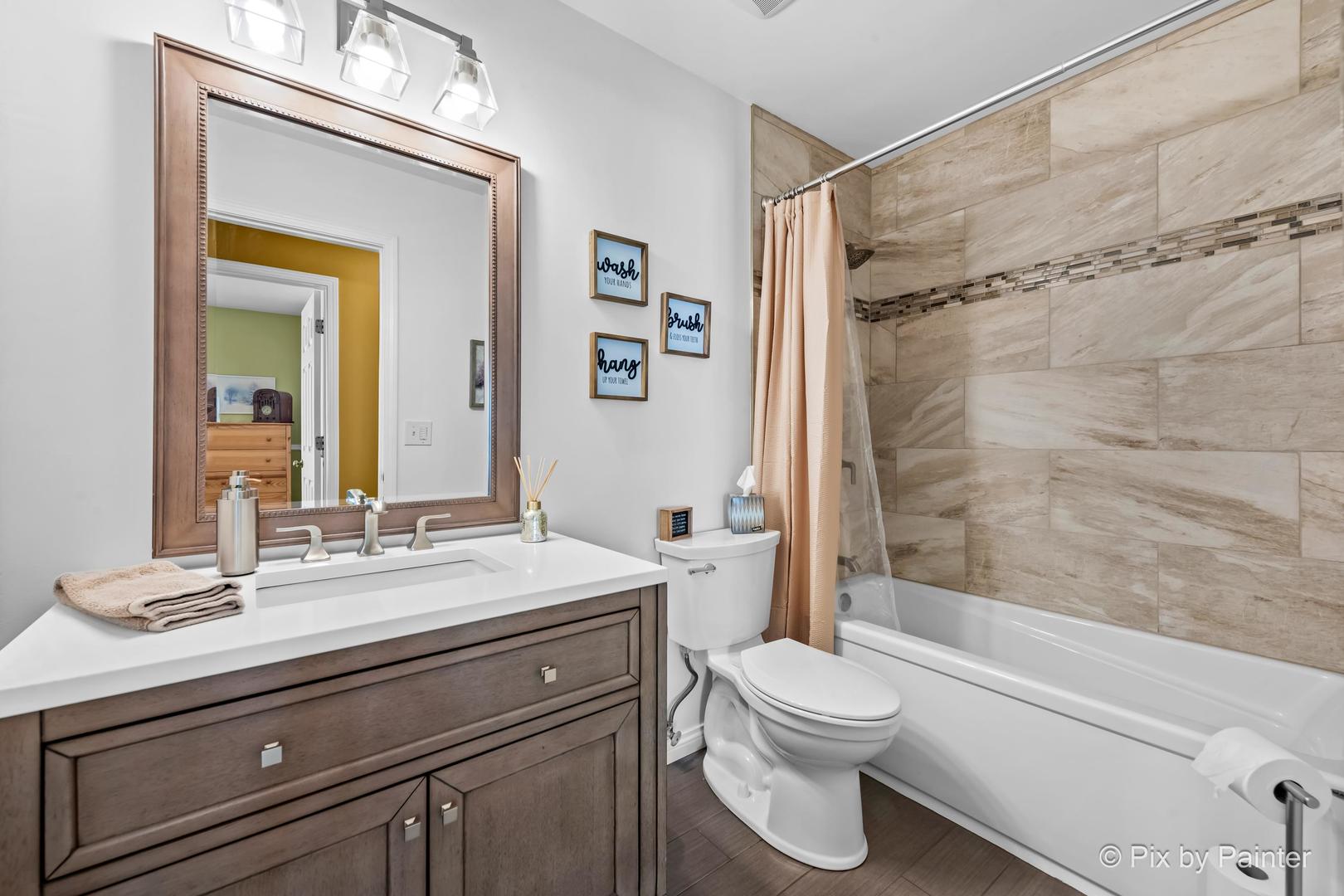 336 Claire Lane Cary, IL 60013 - Photo 29 of 29 a bathroom with a toilet a sink and a bathtub