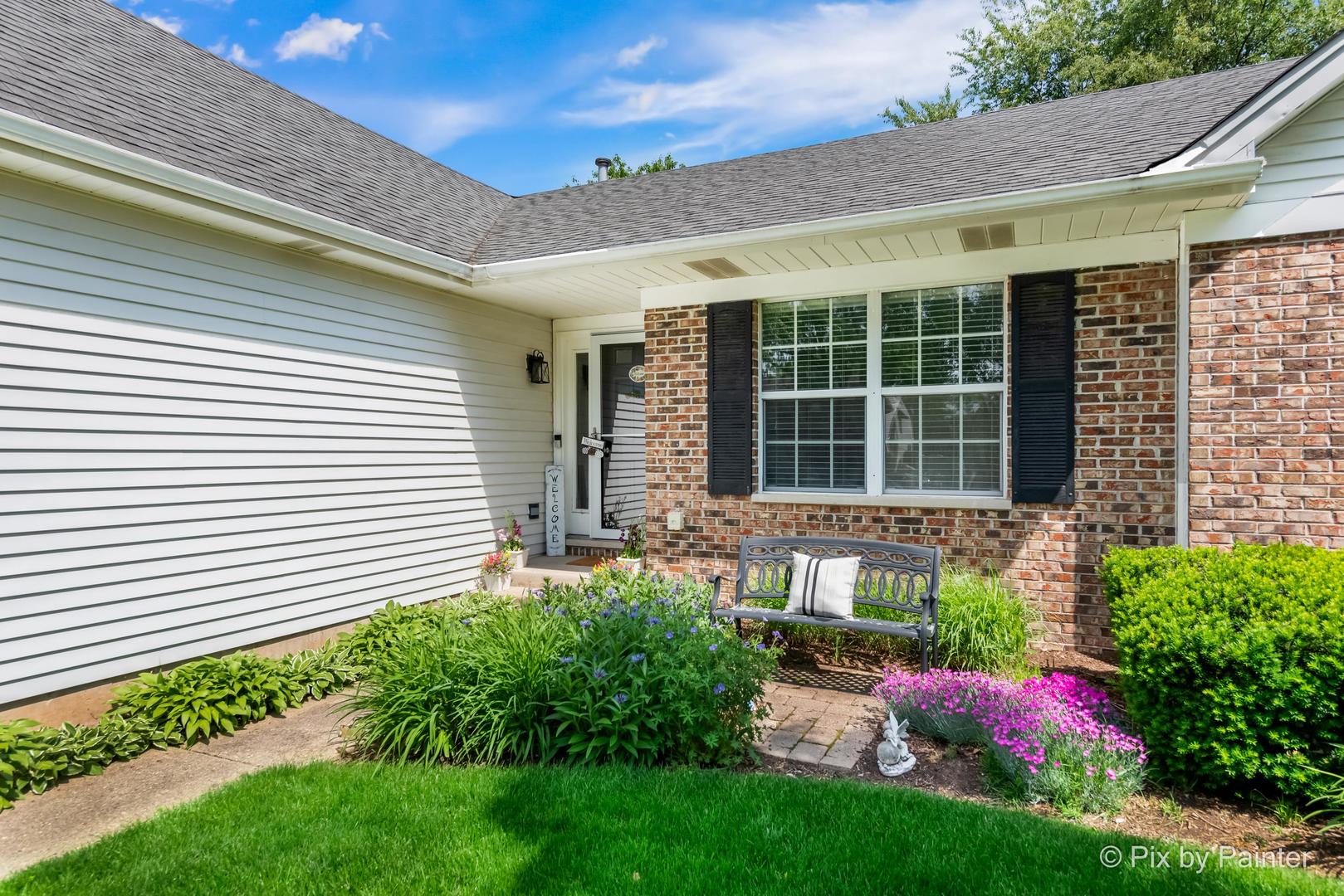 336 Claire Lane Cary, IL 60013 - Photo 3 of 29 a front view of a house with a yard and potted plants