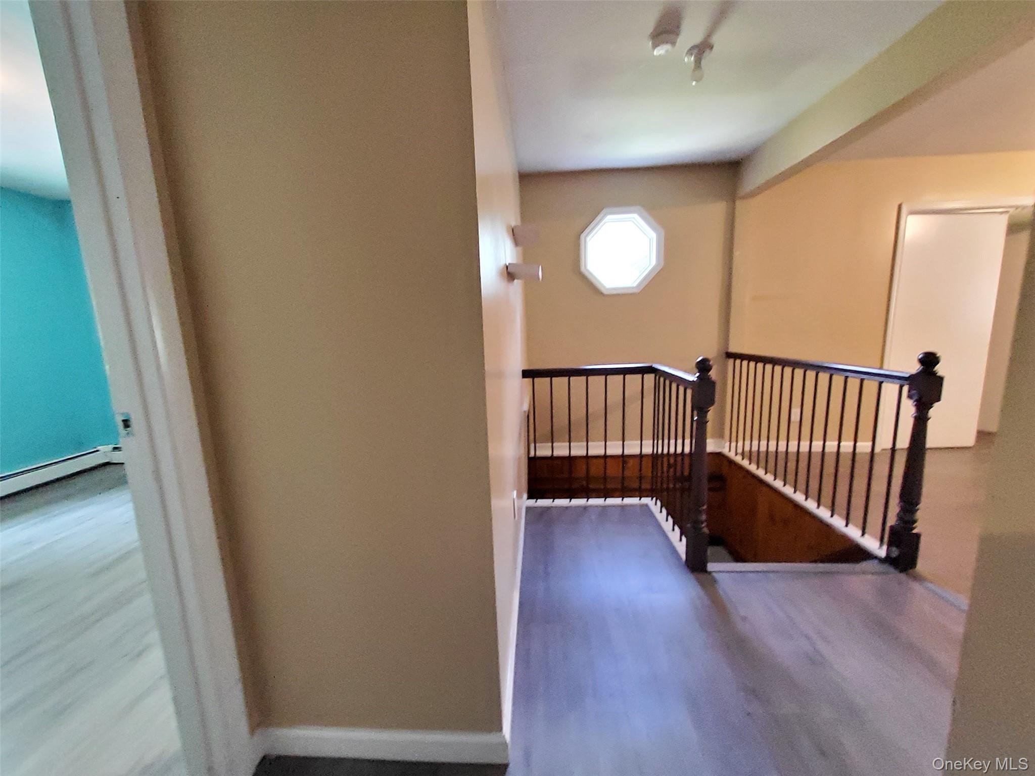 469 Hillside Road Monroe, NY 10950 - Photo 11 of 20 a view of a hallway with wooden floor and staircase