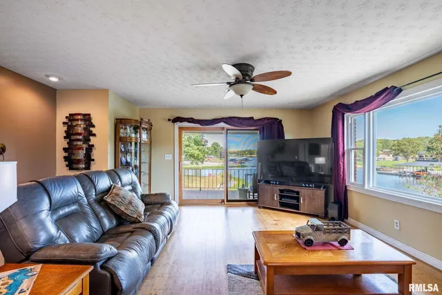 a living room with furniture and a floor to ceiling window