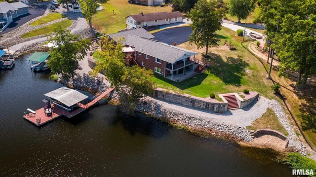 an aerial view of a house with a garden and swimming pool